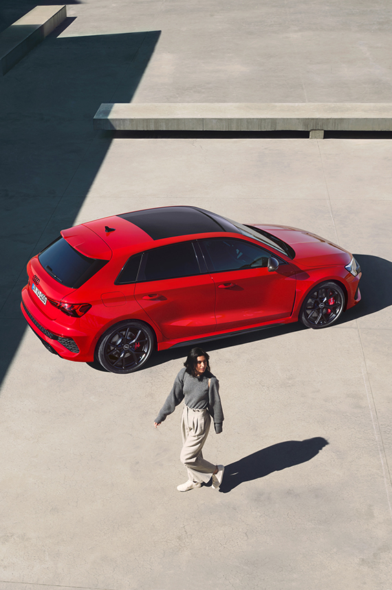 Audi RS 3 Sportback sideways from above and a young woman